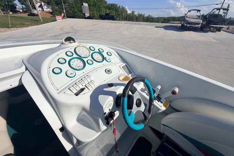 Slide: The Image of Cockpit view of a 1999 Baja 29 Outlaw boat with gauges and steering wheel. - 18