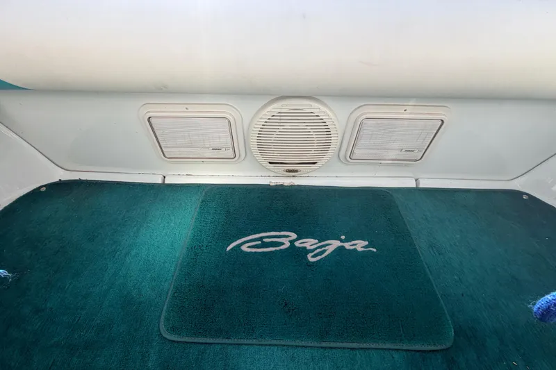 Slide: The Image of Interior of a 1999 Baja 29 Outlaw boat with branded carpet and speaker. - 19