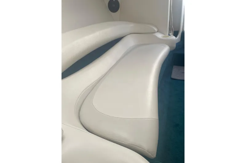 Slide: The Image of 1999 Baja 29 Outlaw boat interior with white leather seating and blue carpet. - 26