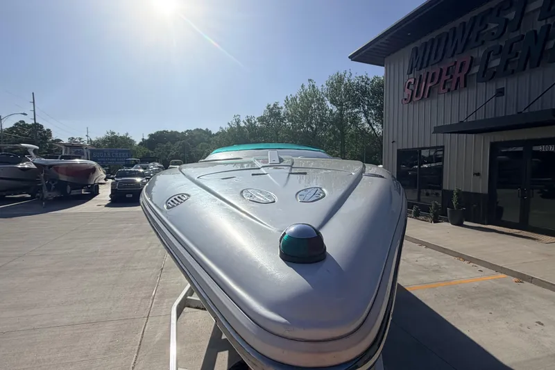 Slide: The Image of 1999 Baja 29 Outlaw boat displayed outdoors at Midwest Super Center. - 8