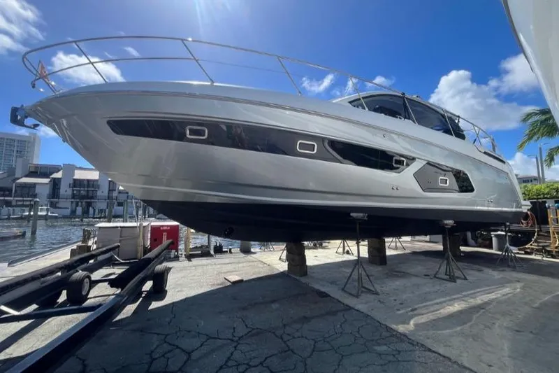 The Image of 2020 Azimut Atlantis 43 yacht on dry dock under clear blue sky. - 0