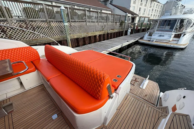Slide: The Image of Azimut Atlantis 43 yacht, 2016 model, featuring vibrant orange seating and docked at a marina. - 14