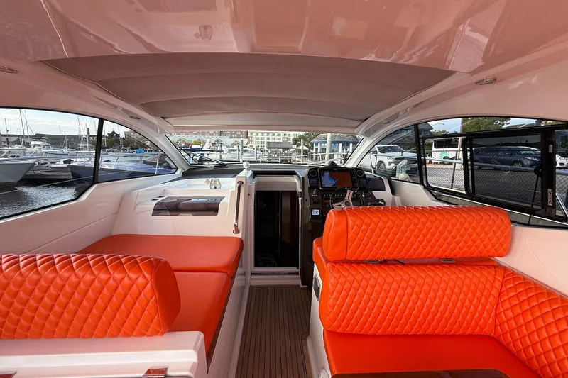 Slide: The Image of Interior of 2016 Azimut Atlantis 43 yacht with vibrant orange seating and modern dashboard. - 17