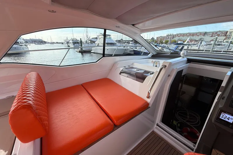 Slide: The Image of Interior of 2016 Azimut Atlantis 43 yacht with orange seating, overlooking marina. - 18