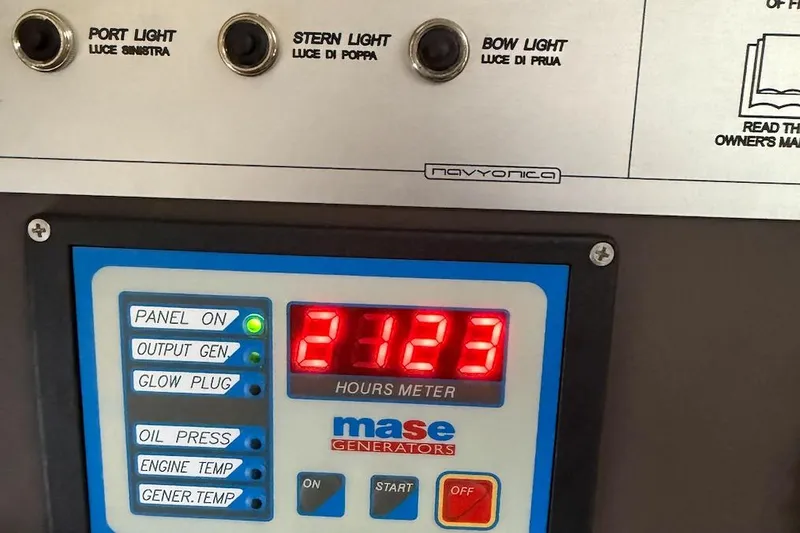 Slide: The Image of Control panel of a 2016 Azimut Atlantis 43 with hours meter and light switches. - 25