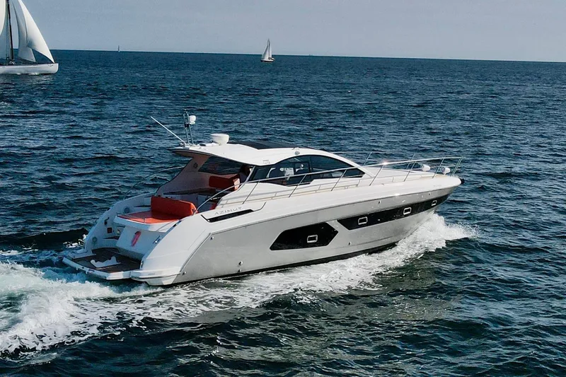 Slide: The Image of 2016 Azimut Atlantis 43 yacht cruising on open sea with sailboats in background. - 3