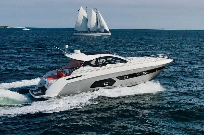 Slide: The Image of Azimut Atlantis 43 yacht cruising on open sea, 2016 model, with sailboat in background. - 4