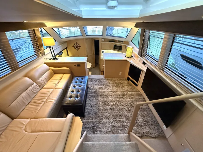 Slide: The Image of Interior of a 1999 Carver 406 yacht with sofa and table. - 12