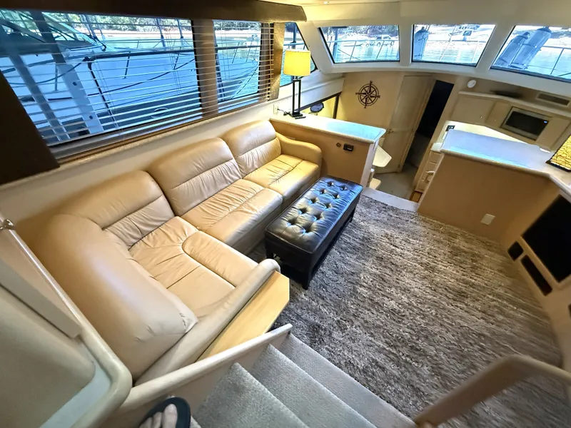 Slide: The Image of Interior of a 1999 Carver 406 yacht with cozy seating area. - 13