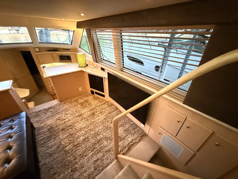 Slide: The Image of Interior of a 1999 Carver 406 yacht with sofa and carpet. - 14
