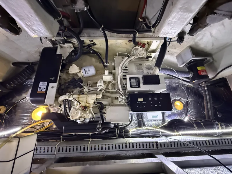Slide: The Image of Engine room of a 1999 Carver 406 with technical components. - 32