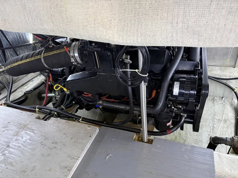 Slide: The Image of Engine compartment of 1999 Carver 406 boat with visible hoses and cables. - 35