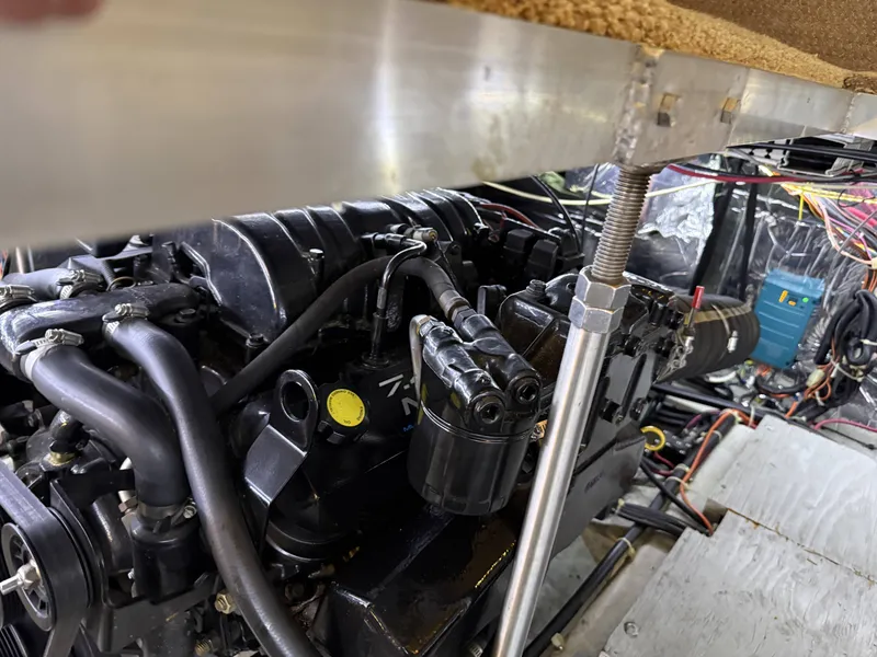 Slide: The Image of Engine compartment of a 1999 Carver 406 boat with visible components. - 36
