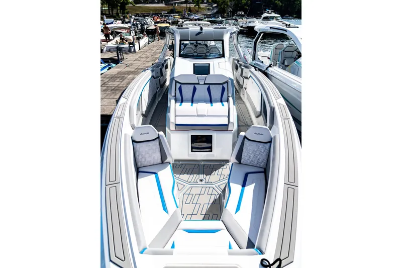 Slide: The Image of Luxurious AMP 433 boat interior, 2026 model, featuring sleek seating and modern design at a marina. - 15