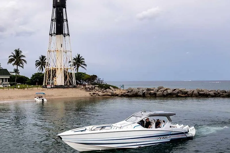 Slide: The Image of Speedboat AMP 433 cruising near a lighthouse and palm trees, 2026 model. - 3