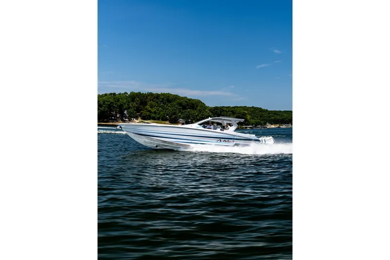Slide: The Image of 2026 AMP 433 boat cruising on a lake under a clear blue sky. - 4