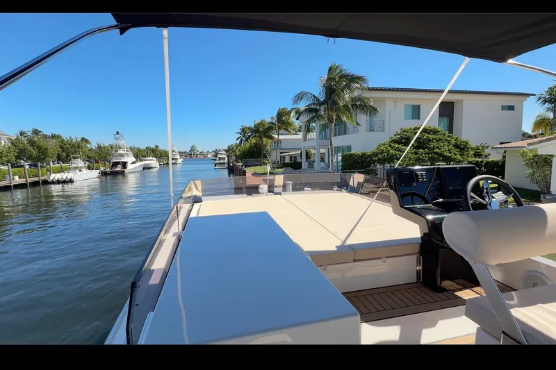 Slide: The Image of 2026 Cobra Yachts Seamaster 45 on a sunny waterfront, showcasing luxury deck and helm. - 10