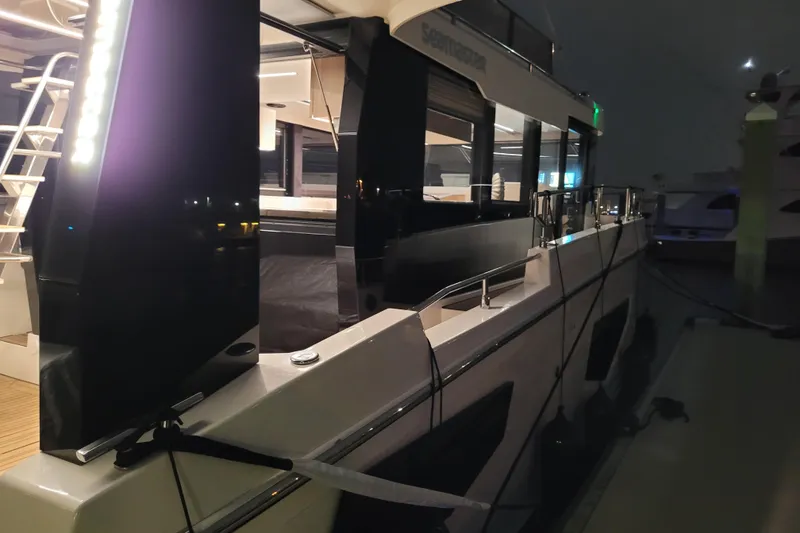 Slide: The Image of 2026 Cobra Yachts Seamaster 45 docked at night, illuminated exterior view. - 16