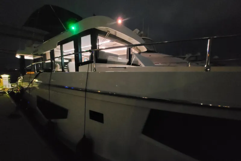 Slide: The Image of 2026 Cobra Yachts Seamaster 45 docked at night, illuminated interior, sleek design. - 17