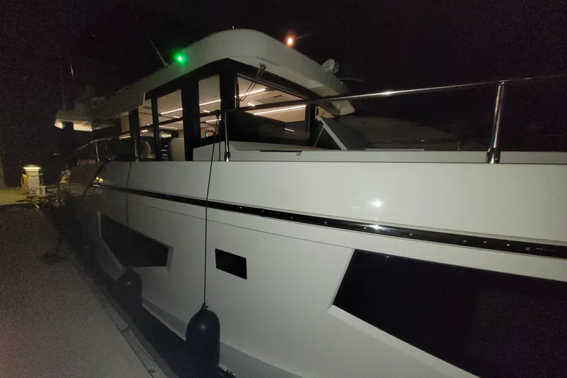 Slide: The Image of 2026 Cobra Yachts Seamaster 45 docked at night, illuminated interior. - 18