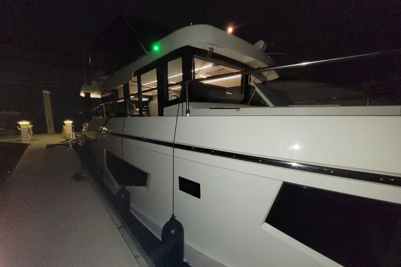 Slide: The Image of 2026 Cobra Yachts Seamaster 45 docked at night, illuminated interior lights. - 19