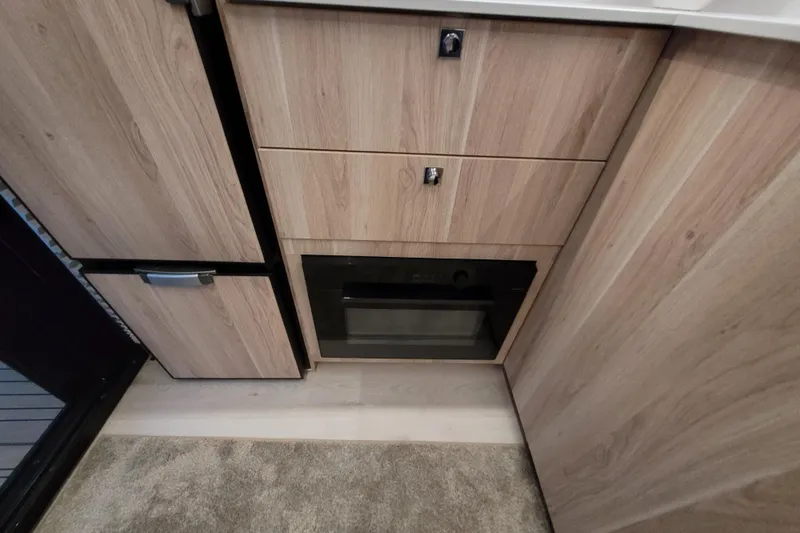 Slide: The Image of Interior of 2026 Cobra Yachts Seamaster 45, featuring wood cabinetry and built-in appliances. - 30