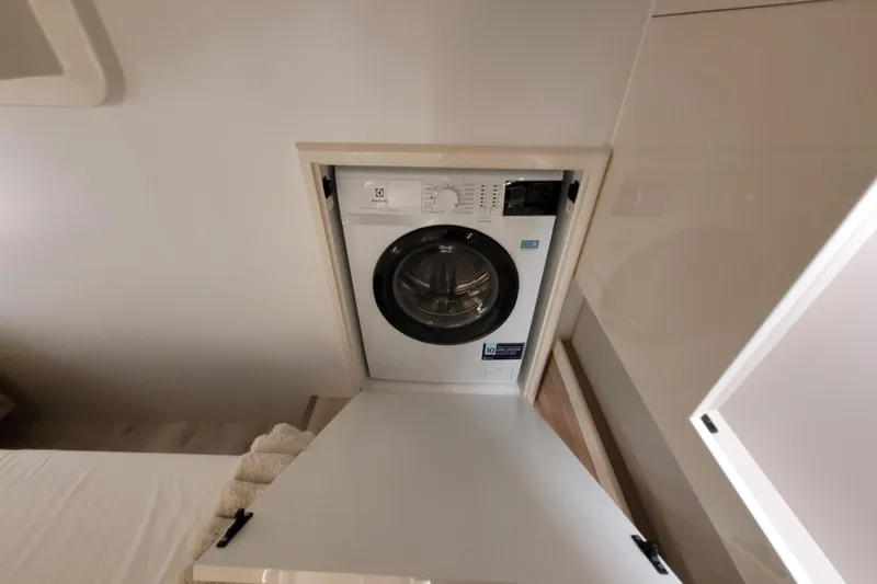 Slide: The Image of Compact washing machine in Cobra Yachts Seamaster 45, 2026 model, integrated into cabin space. - 56