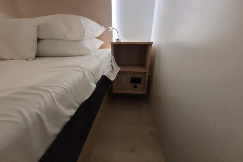 Slide: The Image of Cozy cabin interior of 2026 Cobra Yachts Seamaster 45 with bed and wooden nightstand. - 57