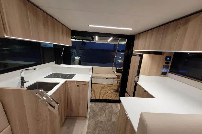 Slide: The Image of Modern kitchen interior of 2026 Cobra Yachts Seamaster 45, featuring sleek wood cabinetry and appliances. - 66