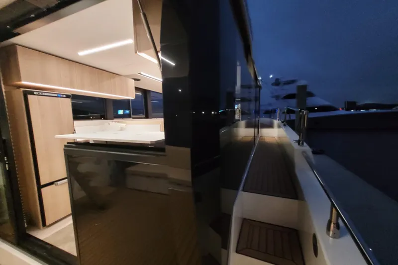 Slide: The Image of Modern interior of 2026 Cobra Yachts Seamaster 45, featuring sleek kitchen design at night. - 70