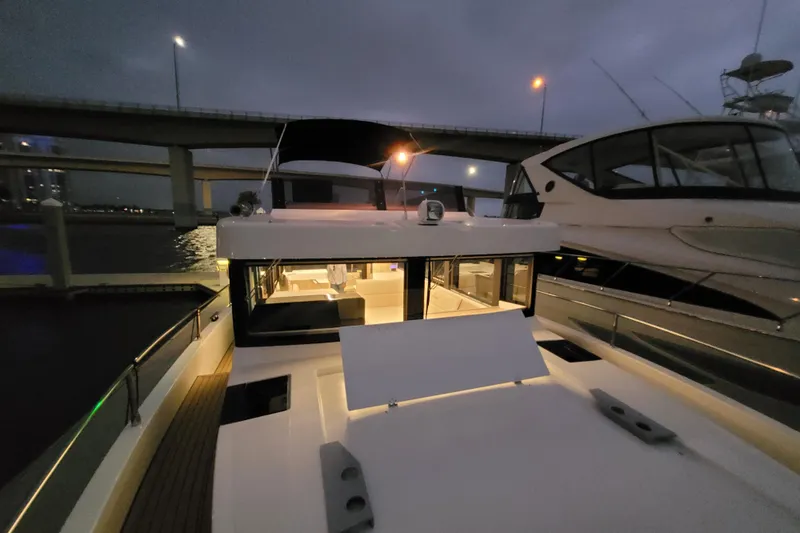 Slide: The Image of 2026 Cobra Yachts Seamaster 45 docked at night under bridge lights. - 73