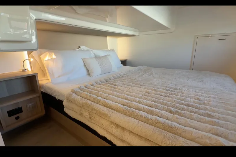 Slide: The Image of Luxurious bedroom interior of 2026 Cobra Yachts Seamaster 45, featuring plush bedding and ambient lighting. - 76