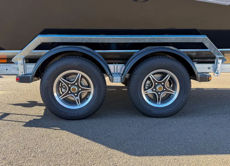 Slide: The Image of Dual trailer wheels of a 2025 Hewescraft 200 ProV boat trailer. - 18
