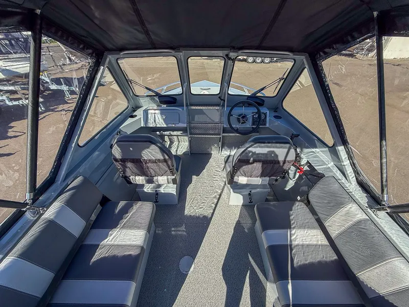 Slide: The Image of Interior of 2025 Hewescraft 200 ProV boat, featuring modern seating and helm. - 7