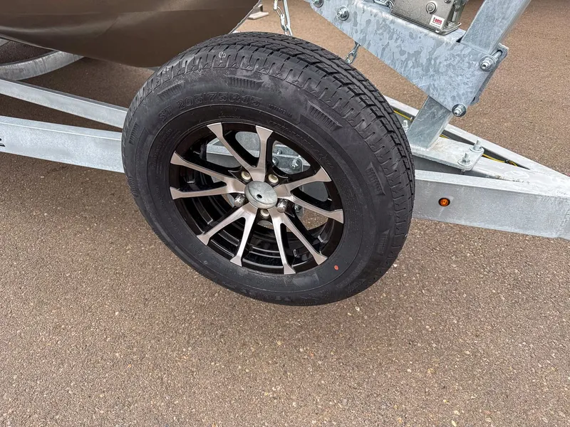 Slide: The Image of Stabicraft 2050 Treker 2026 trailer tire on asphalt. - 24