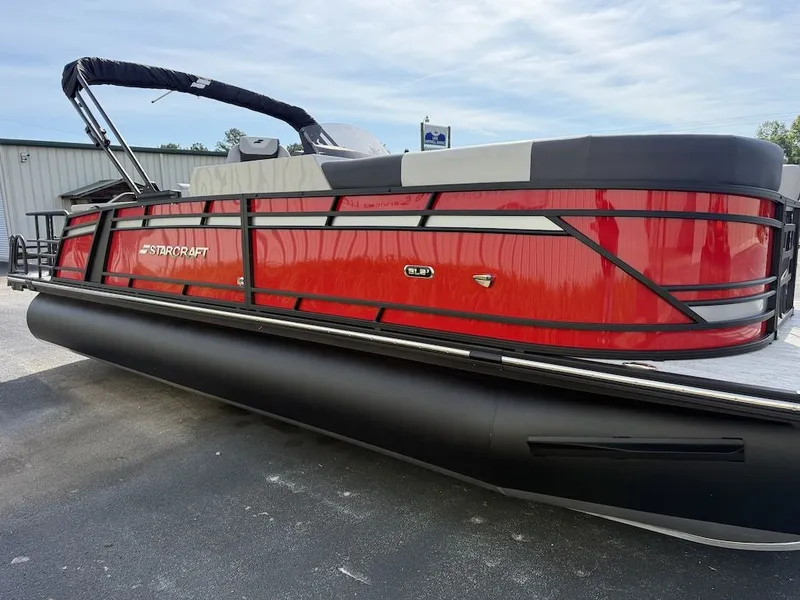Slide: The Image of 2026 Starcraft SLS 3 Q DH pontoon boat in red, side view. - 3