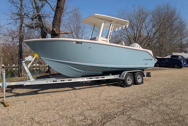 The Image of 2025 Sailfish 232 CC boat on trailer, parked outdoors on a sunny day. - 0