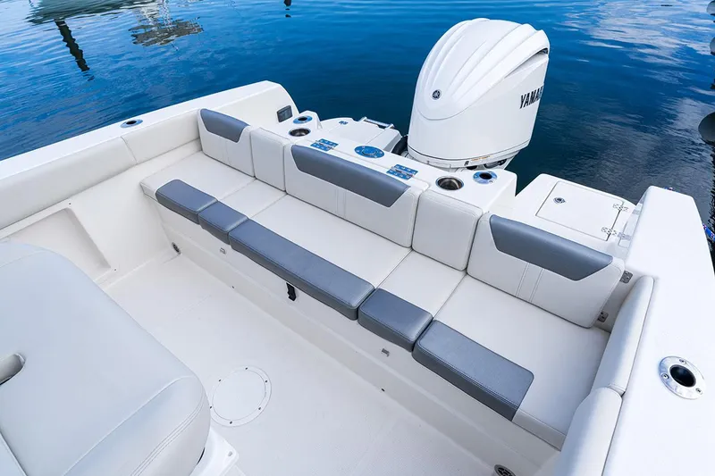 Slide: The Image of Manufacturer Provided Image: 2025 Sailfish 232 CC boat interior with cushioned seating and Yamaha outboard motor. - 8
