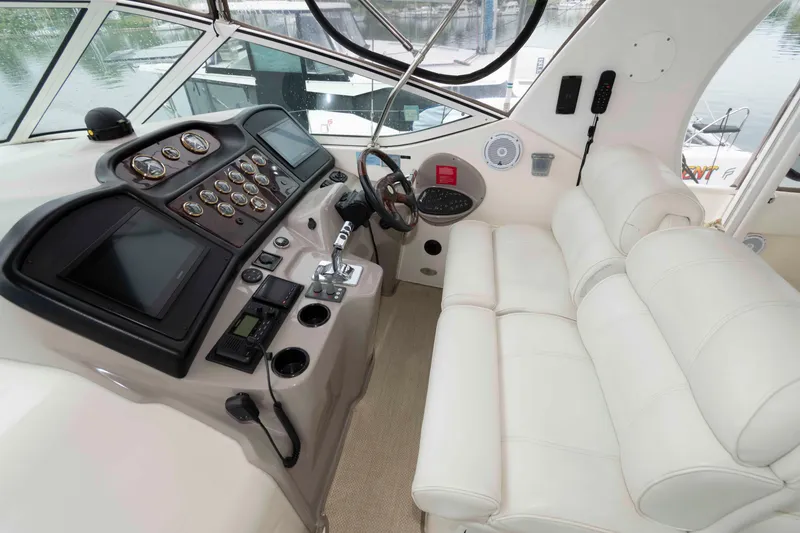 Slide: The Image of Cockpit of 2003 Cruisers Yachts 4050 Express with white seating and control panel. - 10