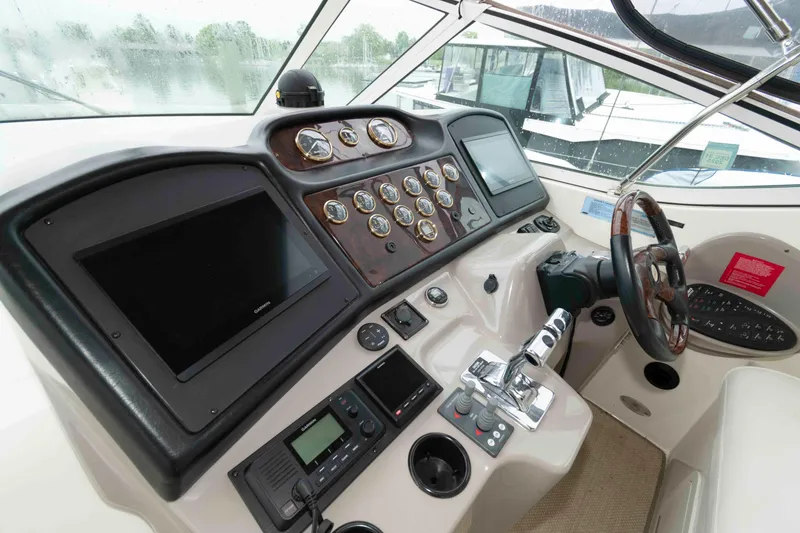 Slide: The Image of Helm of 2003 Cruisers Yachts 4050 Express with modern navigation instruments and controls. - 11