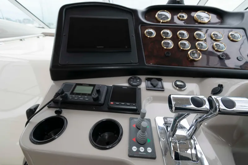 Slide: The Image of Dashboard of a 2003 Cruisers Yachts 4050 Express with navigation controls and gauges. - 13