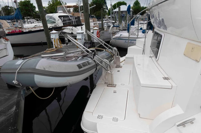Slide: The Image of 2003 Cruisers Yachts 4050 Express docked with inflatable boat attached. - 15