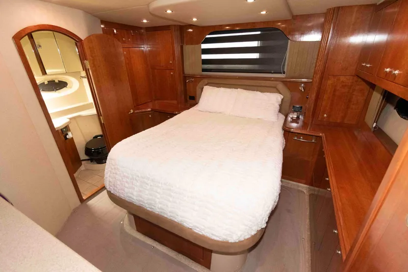 Slide: The Image of Luxurious cabin interior of 2003 Cruisers Yachts 4050 Express with wood finish and cozy bed. - 22