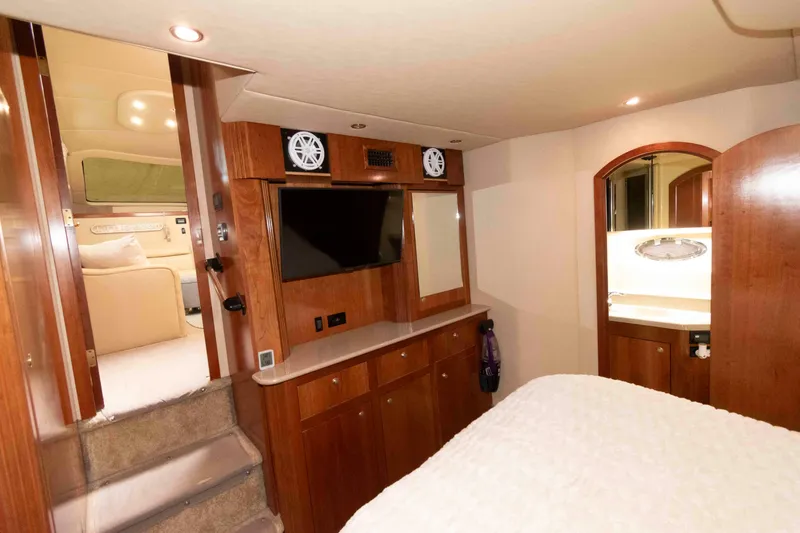 Slide: The Image of Luxurious interior of 2003 Cruisers Yachts 4050 Express with wood cabinetry and modern amenities. - 23