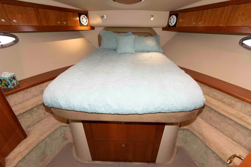 Slide: The Image of Luxurious cabin interior of 2003 Cruisers Yachts 4050 Express with cozy bed and wooden accents. - 25