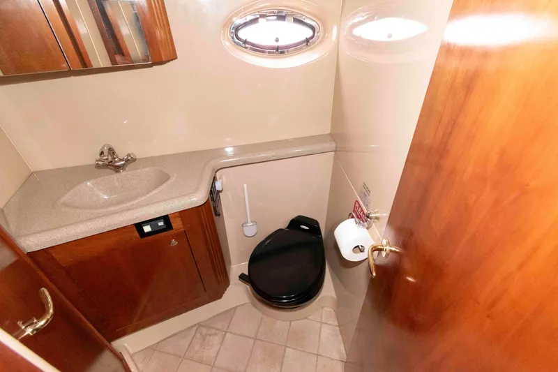 Slide: The Image of Luxurious bathroom in 2003 Cruisers Yachts 4050 Express, featuring sink and toilet. - 26