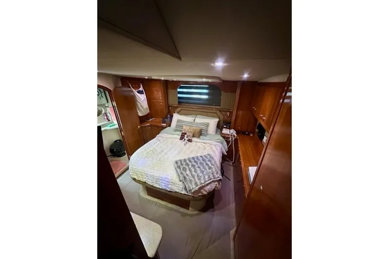 Slide: The Image of Luxurious cabin interior of 2003 Cruisers Yachts 4050 Express with cozy bed and wooden furnishings. - 5