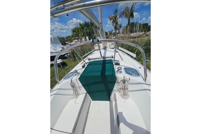 Slide: The Image of Interior of 1997 Beneteau Oceanis Clipper 321 with blue sofa and wooden paneling. - 16