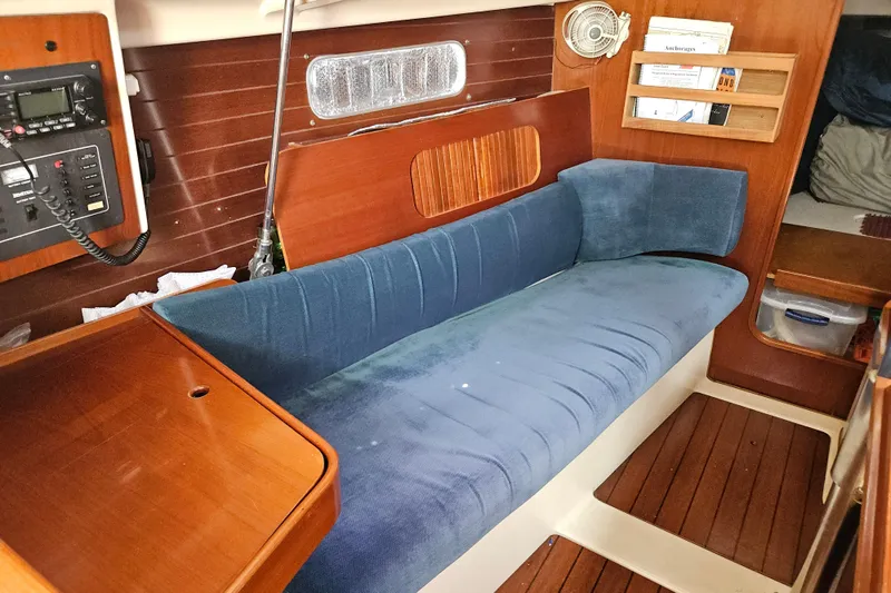 Slide: The Image of 1997 Beneteau Oceanis Clipper 321 yacht kitchen with stove, sink, and wooden cabinetry. - 19