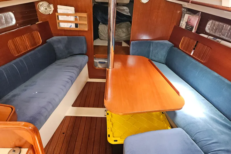 Slide: The Image of Interior cabin of 1997 Beneteau Oceanis Clipper 321 sailboat with blue cushions. - 29